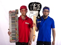 two men holding guitars and keyboards