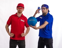two men in blue shirts holding a blue ball
